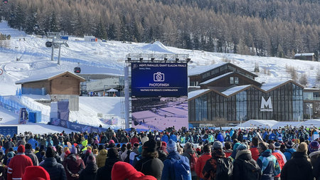Livigno, Italy - February 8, 2026: Spectators watching photofinish results on giant screen during...
