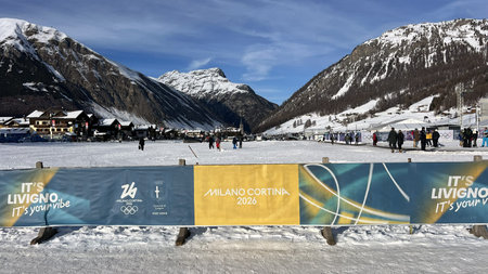 Livigno, Italy - February 8, 2026: Milano Cortina 2026 Winter Olympic Games branding with alpine landscape, mountains, spectators and official banners in Livigno host venueのeditorial素材