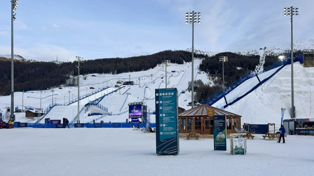 Livigno, Italy - February 9, 2026: Milano Cortina 2026 Olympic Livigno ski big air and slopestyle venue with signage to spectator areas and wooden chaletのeditorial素材