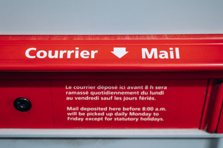 Saguenay, Canada - August 20, 2025: Bilingual Canada Post mail slot with Courrier Mail sign on...