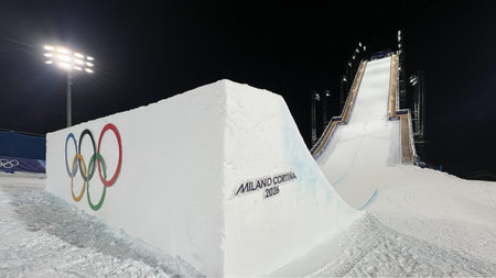 Livigno, Italy - February 17, 2026: Olympic rings and freestyle ski jump at Livigno Aerials and...