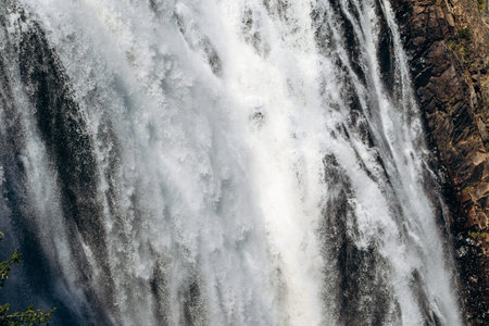 Close up view of powerful water flow of Montmorency Falls waterfall at Parc de la Chute Montmorency...