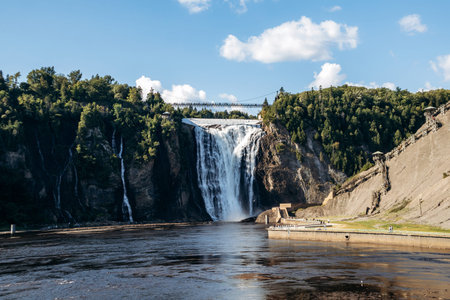 Montmorency Falls waterfall with suspension bridge, observation platforms and staircase at Parc de la Chute Montmorency near Quebec Cityの写真素材