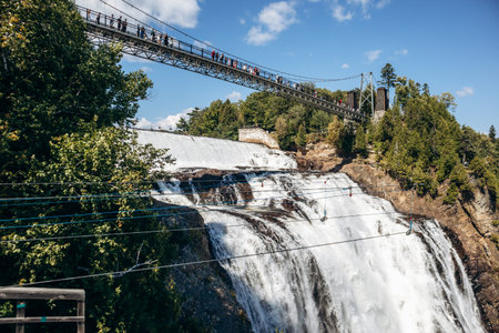 Montmorency Falls waterfall with suspension bridge, observation platforms and staircase at Parc de...