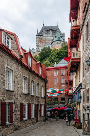 Quebec City, Canada - August 23, 2025: Rue du Cul de Sac street with colorful umbrellas and Chateau...