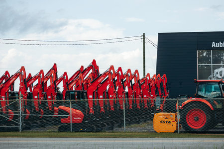 Montreal, Canada - August 24, 2025: Rows of red excavators and construction machinery displayed...