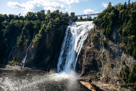 Montmorency Falls waterfall with suspension bridge, observation platforms and staircase at Parc de la Chute Montmorency near Quebec Cityの写真素材