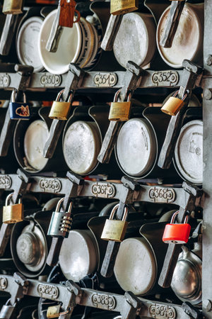 Munich, Germany - April 15, 2025: Storage rack with personal beer steins of regular visitors inside...