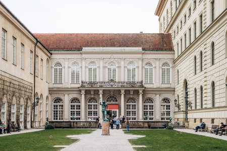 Munich, Germany - April 15, 2025: Courtyard of the Munich Residenz with classical facade, arched windows, central statue and symmetrical garden layoutのeditorial素材