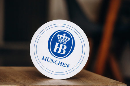 Nice, France - May 8, 2025: HB Munchen beer coaster with blue crown logo, traditional Bavarian...