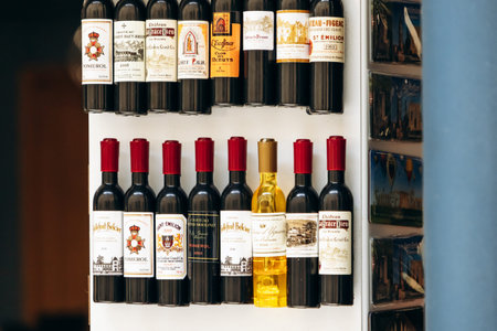 Saint Emilion, France - July 11, 2026: Souvenir magnets shaped like Bordeaux wine bottles with famous regional wine labels displayed in a shop