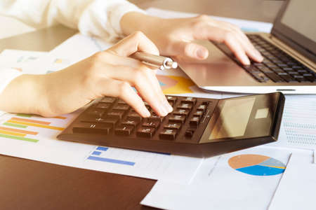 Business women use calculators to calculate And analyze financial expenses. Concepts of financial...