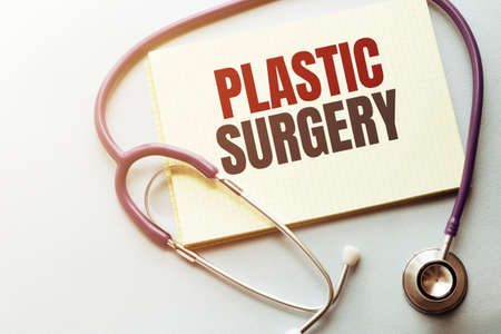 On a purple background a stethoscope with yellow list with text PLASTIC SURGERYの写真素材