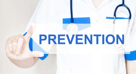 woman doctor with text PREVENTION on the light backgroundの写真素材