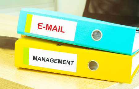 Two office folders with text E MAIL MANAGEMENTの写真素材
