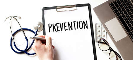 Doctor holding a card with text PREVENTION,medical conceptの写真素材