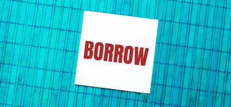 blank note pad with BORROW text on green wooden backgroundの写真素材