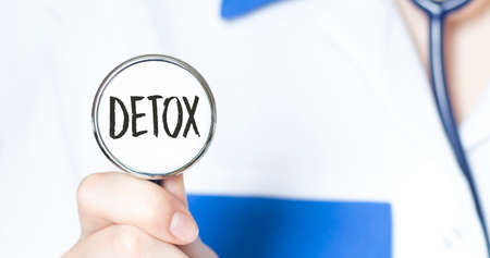 DETOX text written in a stethoscope in doctor hands. Medical concept.の写真素材