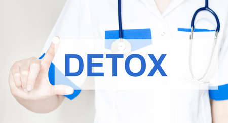 woman doctor with text detox on the light backgroundの写真素材