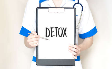 Doctor holding a card with text detox,medical conceptの写真素材