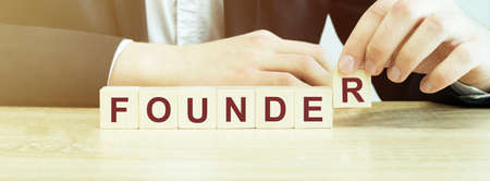 Word FOUNDER made with wood building blocksの写真素材