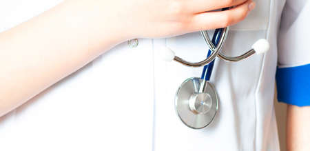 Doctor with stethoscope in a hospitalの写真素材