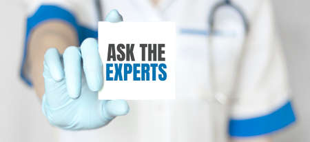 Doctor holding a card with text Ask the Experts, medical conceptの写真素材