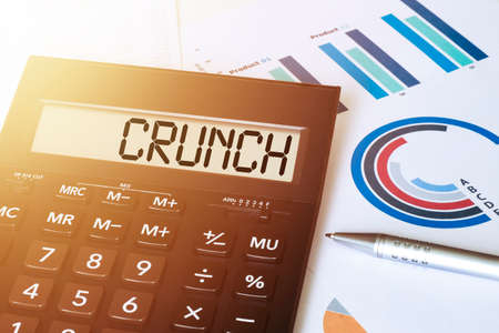Word crunch on calculator. Business and finance concept.の写真素材