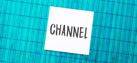 blank note pad with channel text on green wooden backgroundの写真素材