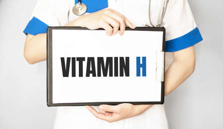 Doctor holding a card with Vitamin H, Medical conceptの写真素材