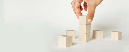 Hand holding blank wooden blocks, cubes, business concept background, mock up, templateの写真素材
