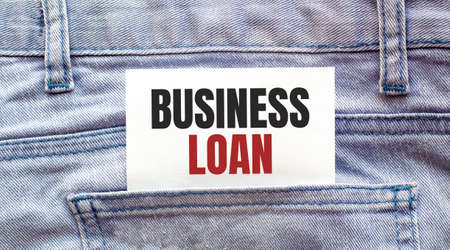 Business loan, words on a white paper stuck out from jeans pocket. Business conceptの写真素材