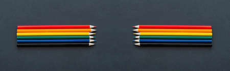 Pencils lie on top Bright social colors lgbt. LGBT colors corrugated cardboard flag. Copy space....