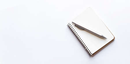 Notepad and pen isolated on white backgroundの写真素材
