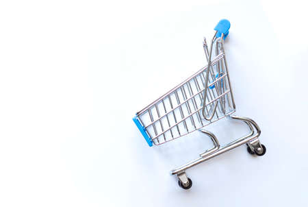 empty shopping cart on blue background, business conceptの写真素材