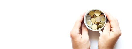 Two man's hands holding a cup of coins, business concept