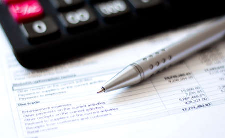 Calculator and pen on diagram chart background