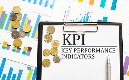 KPI Key Performance Indicator text acronym word throgh magnifying glass lens on office desk table....