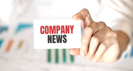 businesswoman holding a card with text COMPANY NEWSの写真素材
