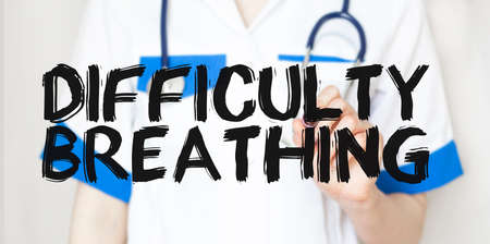 Doctor writing text DIFFICULT BREATHING with marker, medical concept