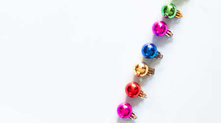 Colorful Christmas wreath decoration from rainbow color baubles on white background