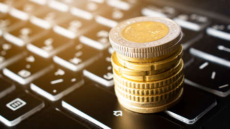 Rising coins on keyboard. Business concept. Financeの写真素材