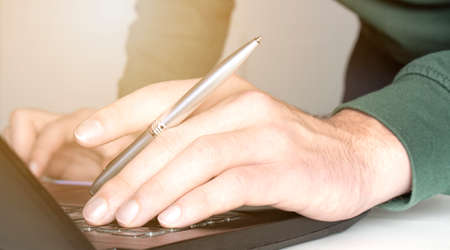 Home office, online working, E learning concept. Businessman typing on laptop computer. Man browsing...