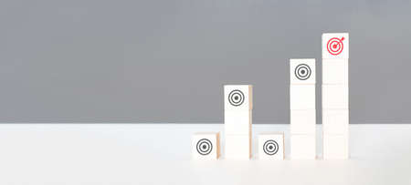 Business strategy concept. Hand arranging symbol with goal icon on wood cube block, Set target,...