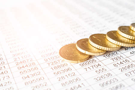 money coin on accounting report sheet background, Saving money or finacial concept.