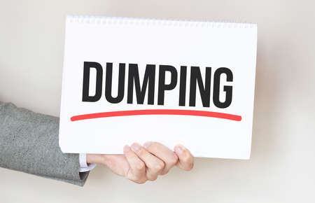 businessman holding a card with text DUMPINGの写真素材