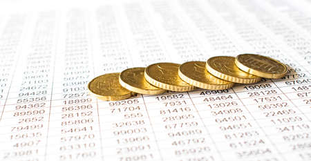money coin on accounting report sheet background, Saving money or finacial concept.