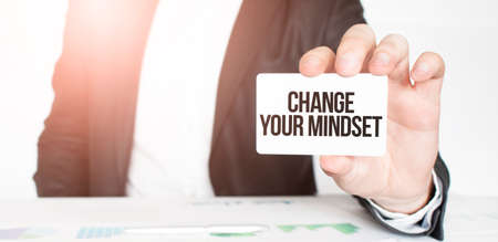 businessman holding a card with text Change Your Mindsetの写真素材