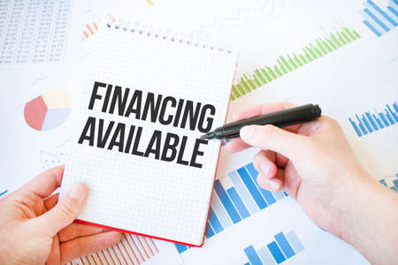 Notepad with text FINANCING AVAILABLE. Diagram and white backgroundの写真素材