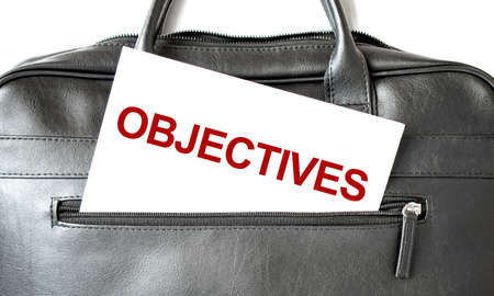 Text OBJECTIVES writing on white paper shit in the black business bag. Business conceptの写真素材